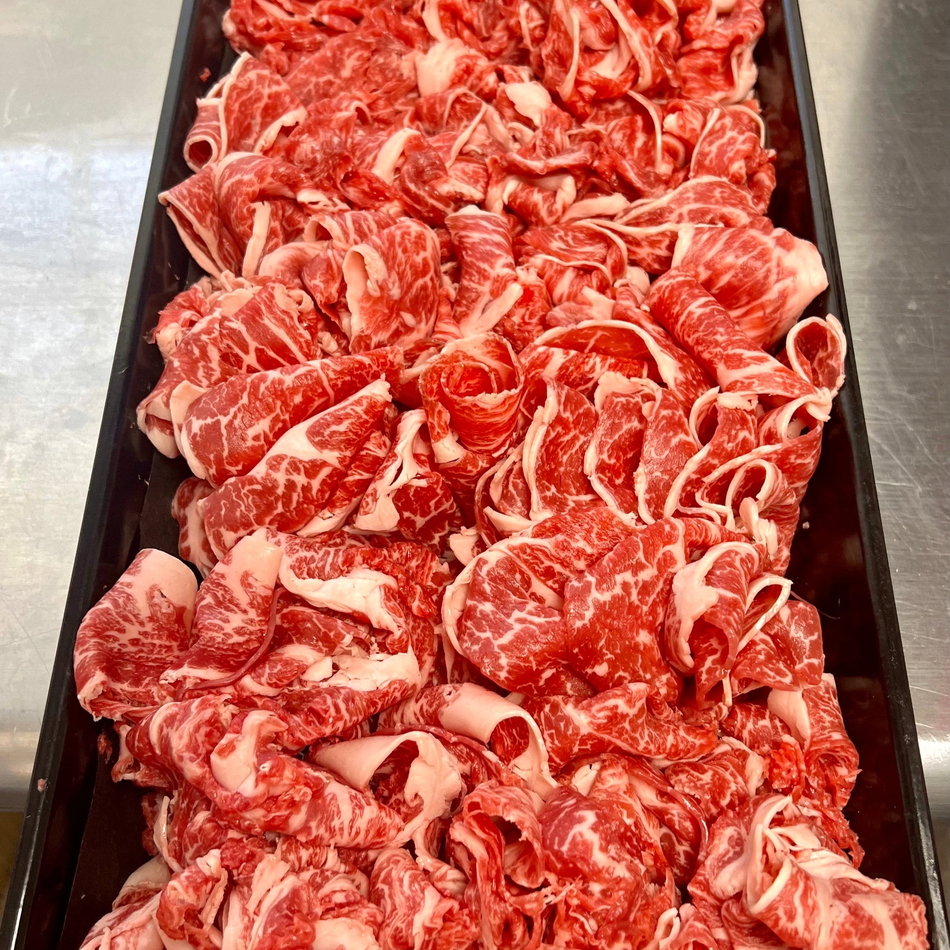 close up look at thin-shaved marbled wagyu beef