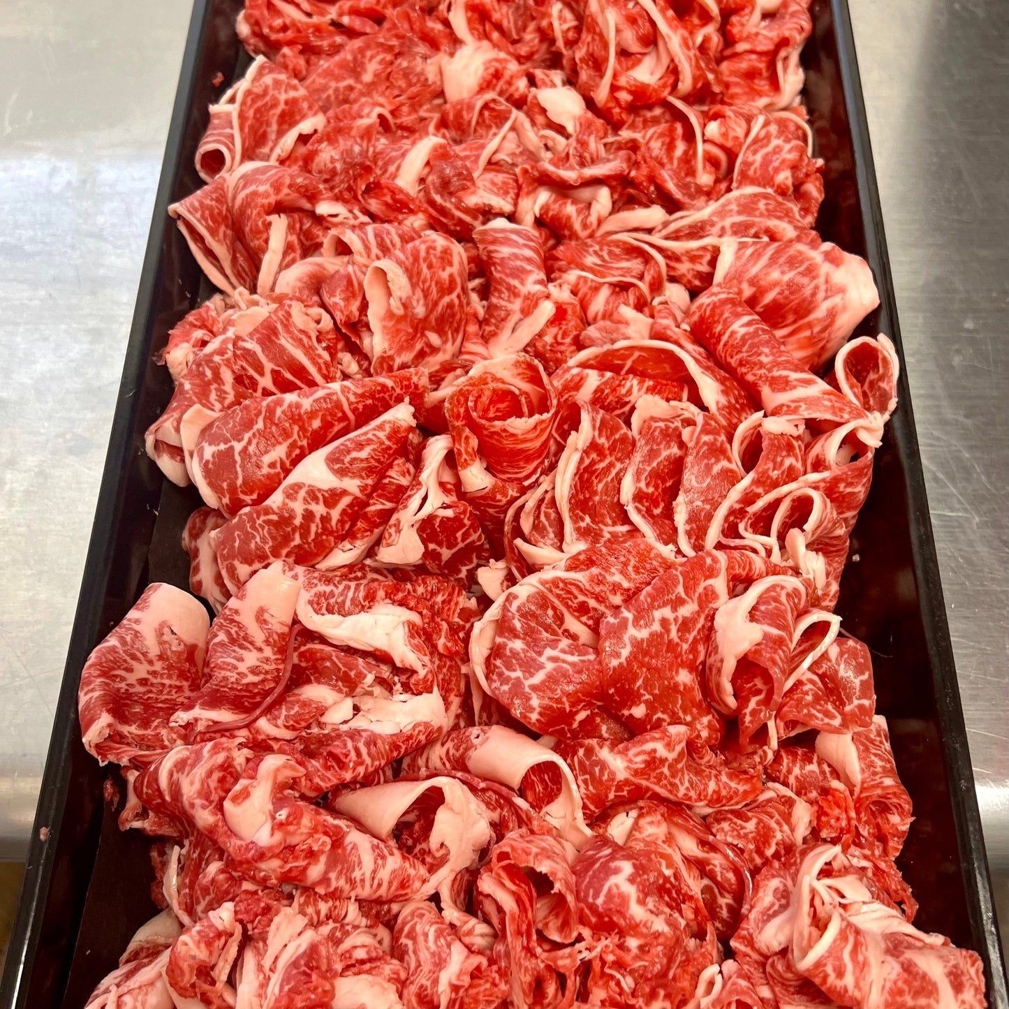 close up look at thin-shaved marbled wagyu beef