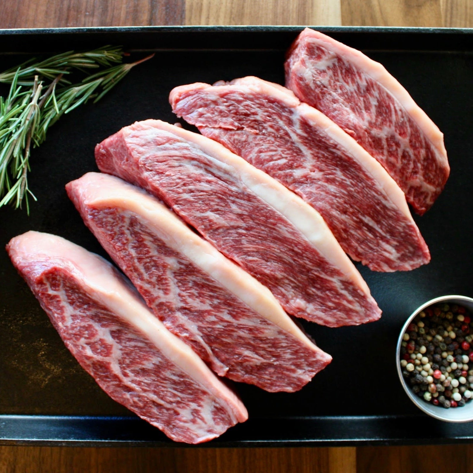 sliced wagyu picanha steak on cast iron pan